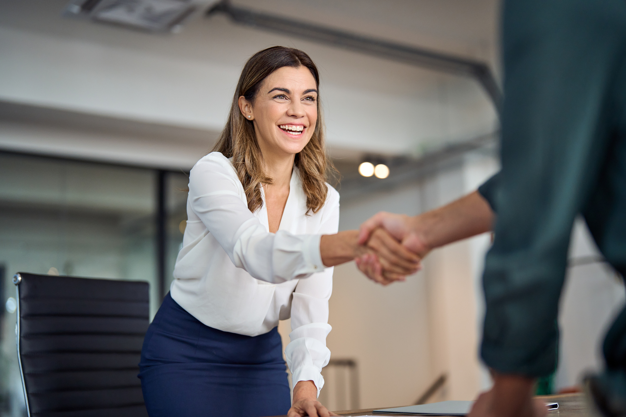 a woman shaking hands with a man